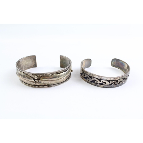 2109 - Two sterling silver Native American bangles - approx. gross weight 67g