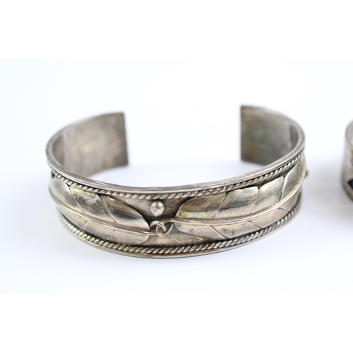 2109 - Two sterling silver Native American bangles - approx. gross weight 67g