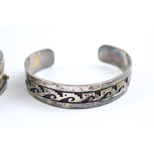 2109 - Two sterling silver Native American bangles - approx. gross weight 67g