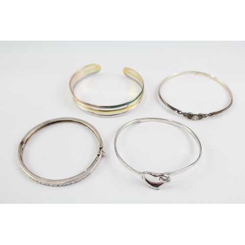 2118 - Four sterling silver bangles to include multi row, heart, Celtic etc. - approx. gross weight 49g