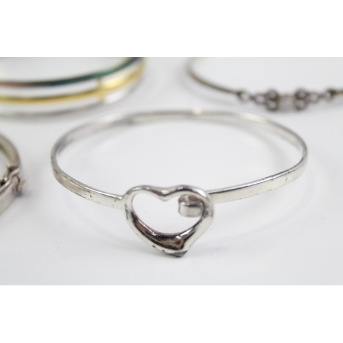 2118 - Four sterling silver bangles to include multi row, heart, Celtic etc. - approx. gross weight 49g