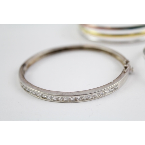 2118 - Four sterling silver bangles to include multi row, heart, Celtic etc. - approx. gross weight 49g