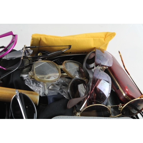 367 - A large collection of sun and reading glasses to include Ralph Lauren etc.