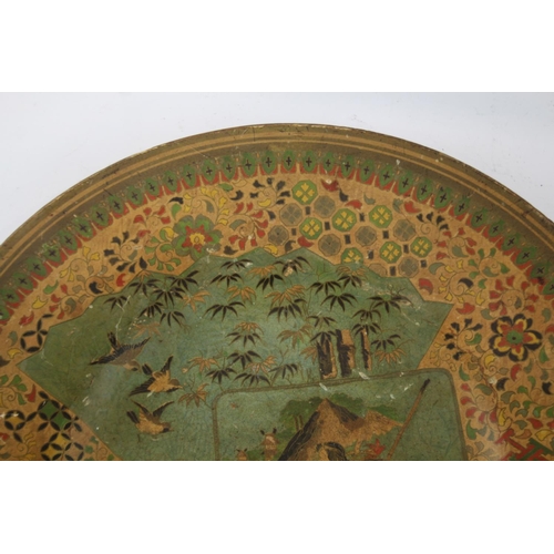 415 - An Oriental lacquered papier-mâché charger/dish