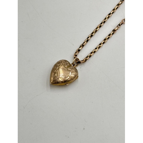 2125 - A Victorian yellow metal chain necklace with seed pearl set foliate etched heart shaped locket - app... 