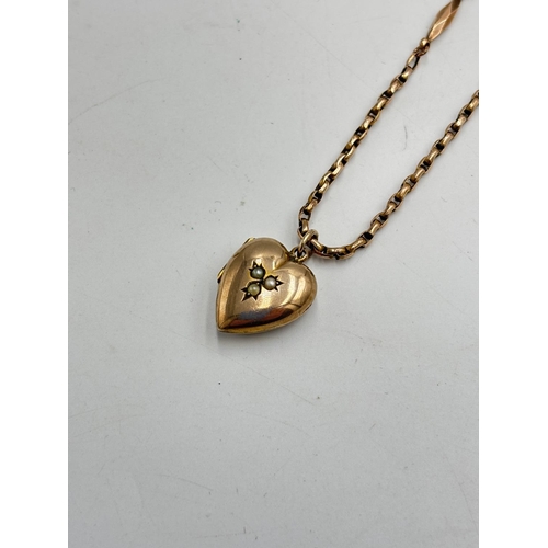 2125 - A Victorian yellow metal chain necklace with seed pearl set foliate etched heart shaped locket - app... 