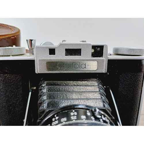 12 - A cased mid 20th century Agilux Agifold folding rangefinder camera for 6x6 images on 120 film fitted... 