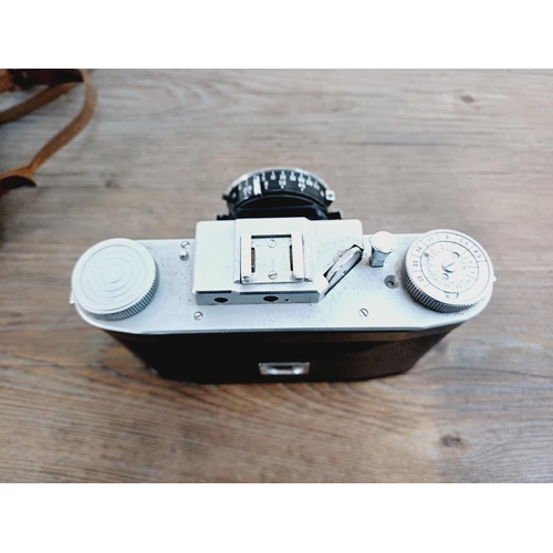 12 - A cased mid 20th century Agilux Agifold folding rangefinder camera for 6x6 images on 120 film fitted... 