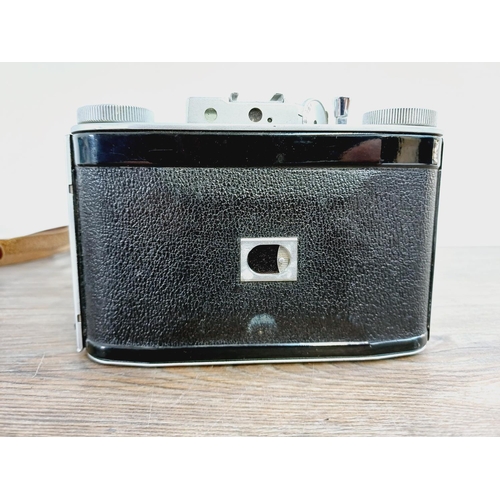 12 - A cased mid 20th century Agilux Agifold folding rangefinder camera for 6x6 images on 120 film fitted... 