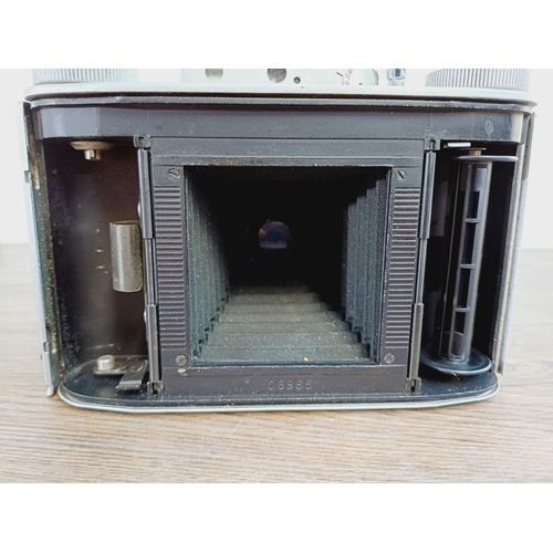 12 - A cased mid 20th century Agilux Agifold folding rangefinder camera for 6x6 images on 120 film fitted... 