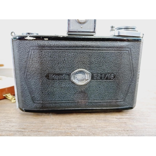 8 - A cased mid 20th century Zeiss Ikon Ikonta 521/16 folding viewfinder camera for 6x6 images on 120 fi... 