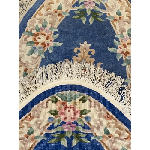 63 - Three Chinese woollen floral pattern rugs