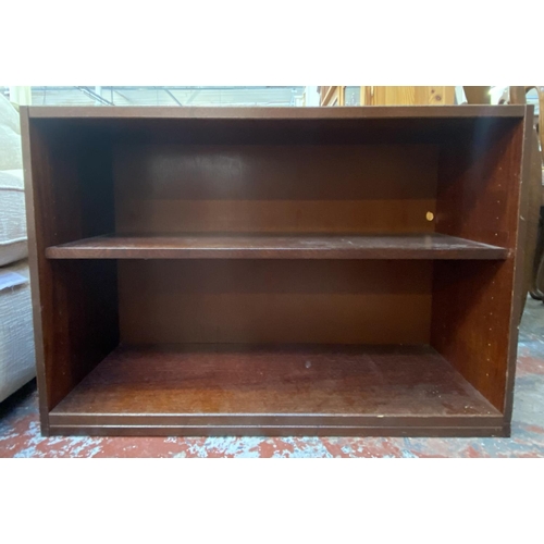 82 - A mahogany effect two tier bookcase - approx. 63cm high x 90cm wide x 35cm deep