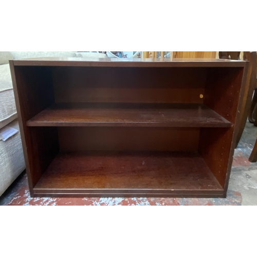 82 - A mahogany effect two tier bookcase - approx. 63cm high x 90cm wide x 35cm deep