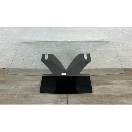 164 - A contemporary glass top coffee table on black faux leather and glass base - approx. 45cm high x 50c... 