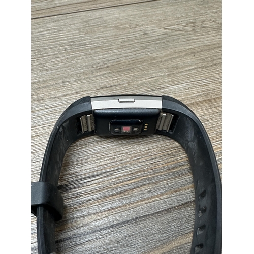 534 - Three Fitbit fitness trackers to include Fitbit Charge 3, Fitbit 1 etc.