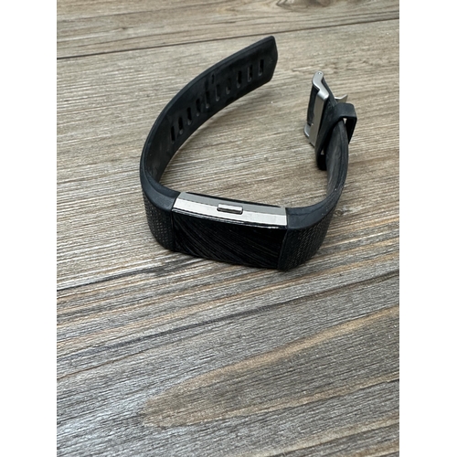 534 - Three Fitbit fitness trackers to include Fitbit Charge 3, Fitbit 1 etc.