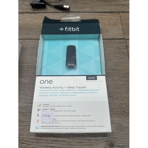 534 - Three Fitbit fitness trackers to include Fitbit Charge 3, Fitbit 1 etc.