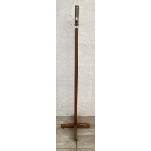 182 - A mid 20th century teak coat stand - approx. 176cm high