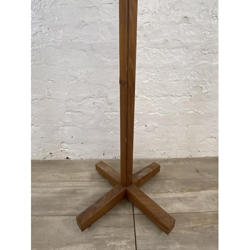 182 - A mid 20th century teak coat stand - approx. 176cm high