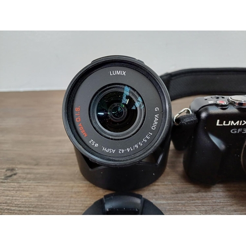 18 - A Panasonic Lumix DMC-GF3 Micro Four Thirds 12mp mirrorless digital system camera fitted with G 1:2.... 