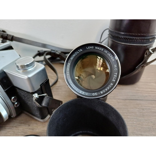 29 - A cased Minolta SRT101 35mm SLR camera fitted with MC Rokkor-PF 1:1.7 f=55mm lens with cased MC Tele... 