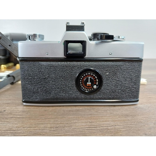 29 - A cased Minolta SRT101 35mm SLR camera fitted with MC Rokkor-PF 1:1.7 f=55mm lens with cased MC Tele... 