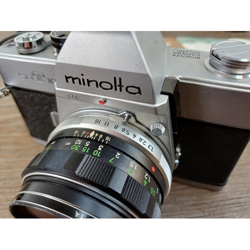 29 - A cased Minolta SRT101 35mm SLR camera fitted with MC Rokkor-PF 1:1.7 f=55mm lens with cased MC Tele... 