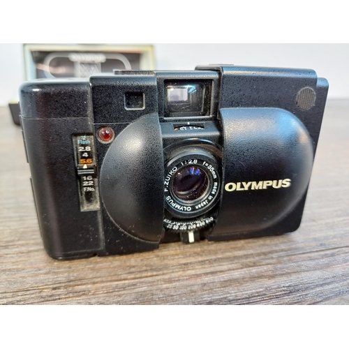 47 - A boxed Olympus XA ultra-compact 35mm rangefinder camera with A11 flash and instruction manual