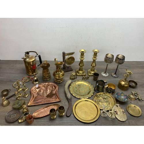 292 - A collection of metalware to include Arts and Crafts copper crumb brush and tray, pair of brass cand... 