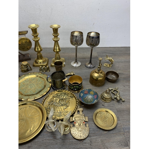 292 - A collection of metalware to include Arts and Crafts copper crumb brush and tray, pair of brass cand... 