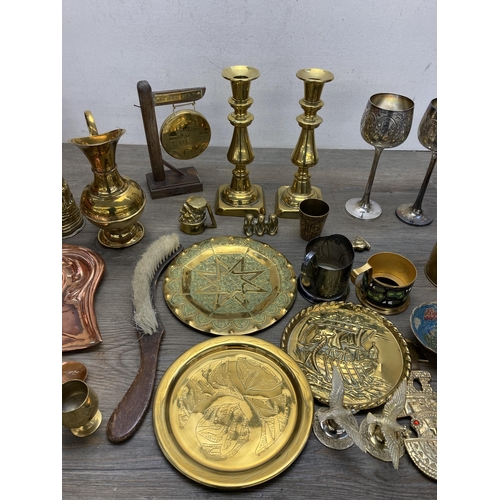 292 - A collection of metalware to include Arts and Crafts copper crumb brush and tray, pair of brass cand... 