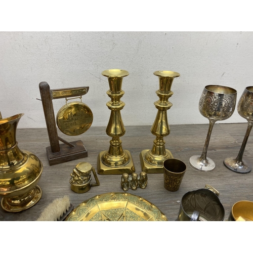 292 - A collection of metalware to include Arts and Crafts copper crumb brush and tray, pair of brass cand... 