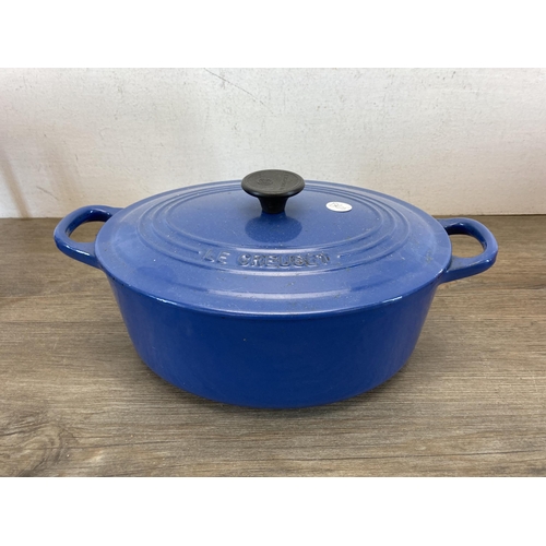 302 - Four pieces of metalware, one Le Creuset blue enamelled cast iron frying pan, one Le Creuset no. 25 ... 