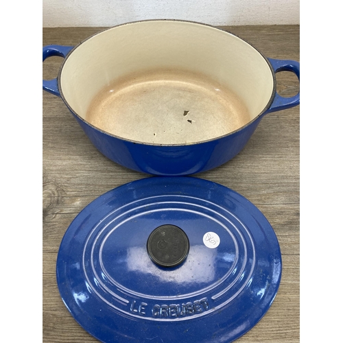 302 - Four pieces of metalware, one Le Creuset blue enamelled cast iron frying pan, one Le Creuset no. 25 ... 