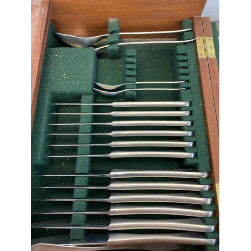 306 - A mid 20th century Old Hall wooden cased canteen of stainless steel cutlery