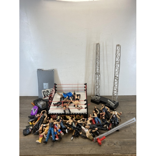 309 - A collection of WWE and WWF wrestling figurines and accessories to include Jeff Hardy, The Rock, The... 