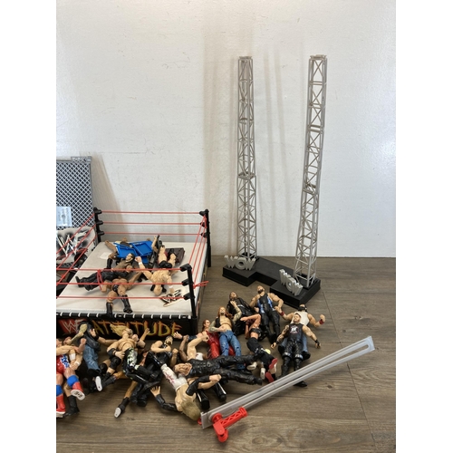 309 - A collection of WWE and WWF wrestling figurines and accessories to include Jeff Hardy, The Rock, The... 