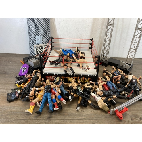 309 - A collection of WWE and WWF wrestling figurines and accessories to include Jeff Hardy, The Rock, The... 