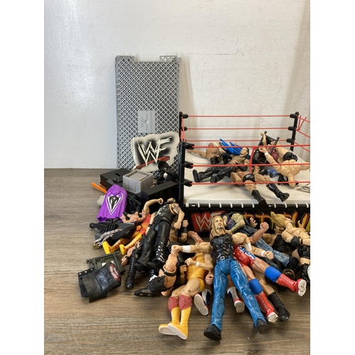 309 - A collection of WWE and WWF wrestling figurines and accessories to include Jeff Hardy, The Rock, The... 