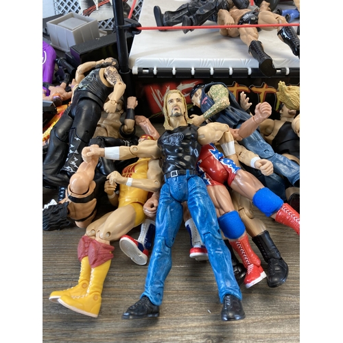 309 - A collection of WWE and WWF wrestling figurines and accessories to include Jeff Hardy, The Rock, The... 