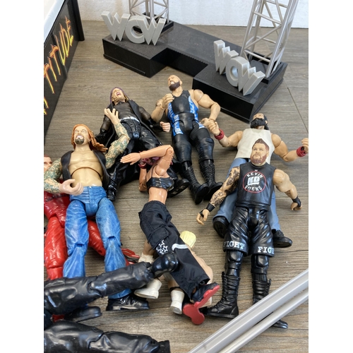 309 - A collection of WWE and WWF wrestling figurines and accessories to include Jeff Hardy, The Rock, The... 