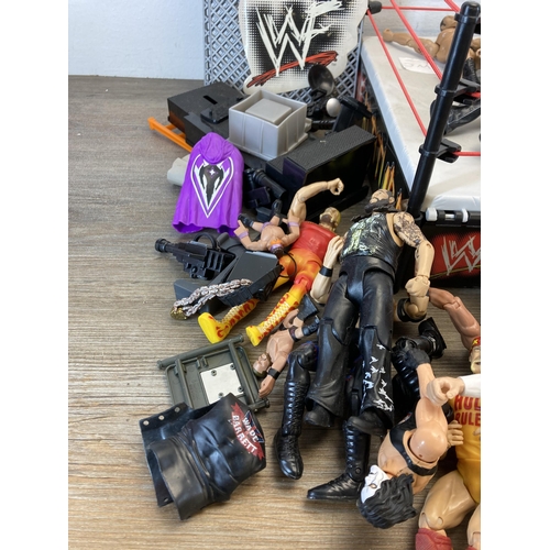 309 - A collection of WWE and WWF wrestling figurines and accessories to include Jeff Hardy, The Rock, The... 