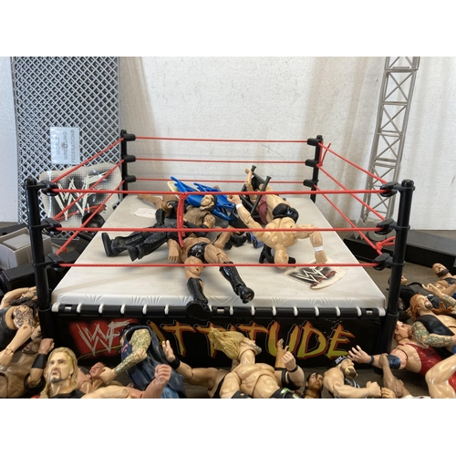 309 - A collection of WWE and WWF wrestling figurines and accessories to include Jeff Hardy, The Rock, The... 