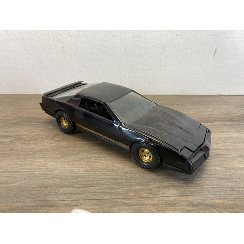 310 - Four items, one The ERTL Co. GMC A-Team van, one The ERTL Co. Smokey And The Bandit Pontiac Firebird... 