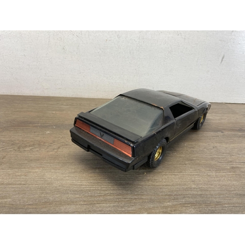 310 - Four items, one The ERTL Co. GMC A-Team van, one The ERTL Co. Smokey And The Bandit Pontiac Firebird... 