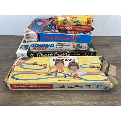 311 - A collection of boxed games to include Paul Daniels Magic Set, Mothercare railway set, MB Ghost Cast... 