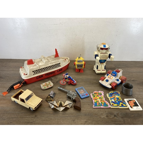 314 - A collection of toys to include 1980s New Bright Morgan TR2 talking robot, Lone Star cap gun, diecas... 