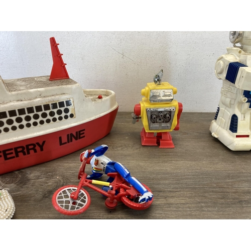 314 - A collection of toys to include 1980s New Bright Morgan TR2 talking robot, Lone Star cap gun, diecas... 