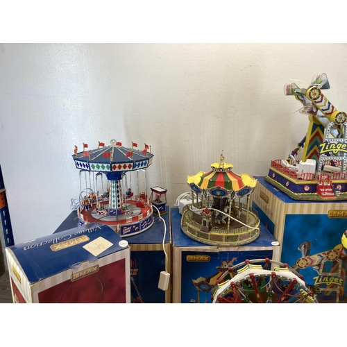 317 - Six boxed Lemax Village Collection display models to include The Cosmic Swing, Le Zinger, Belmont Ca... 